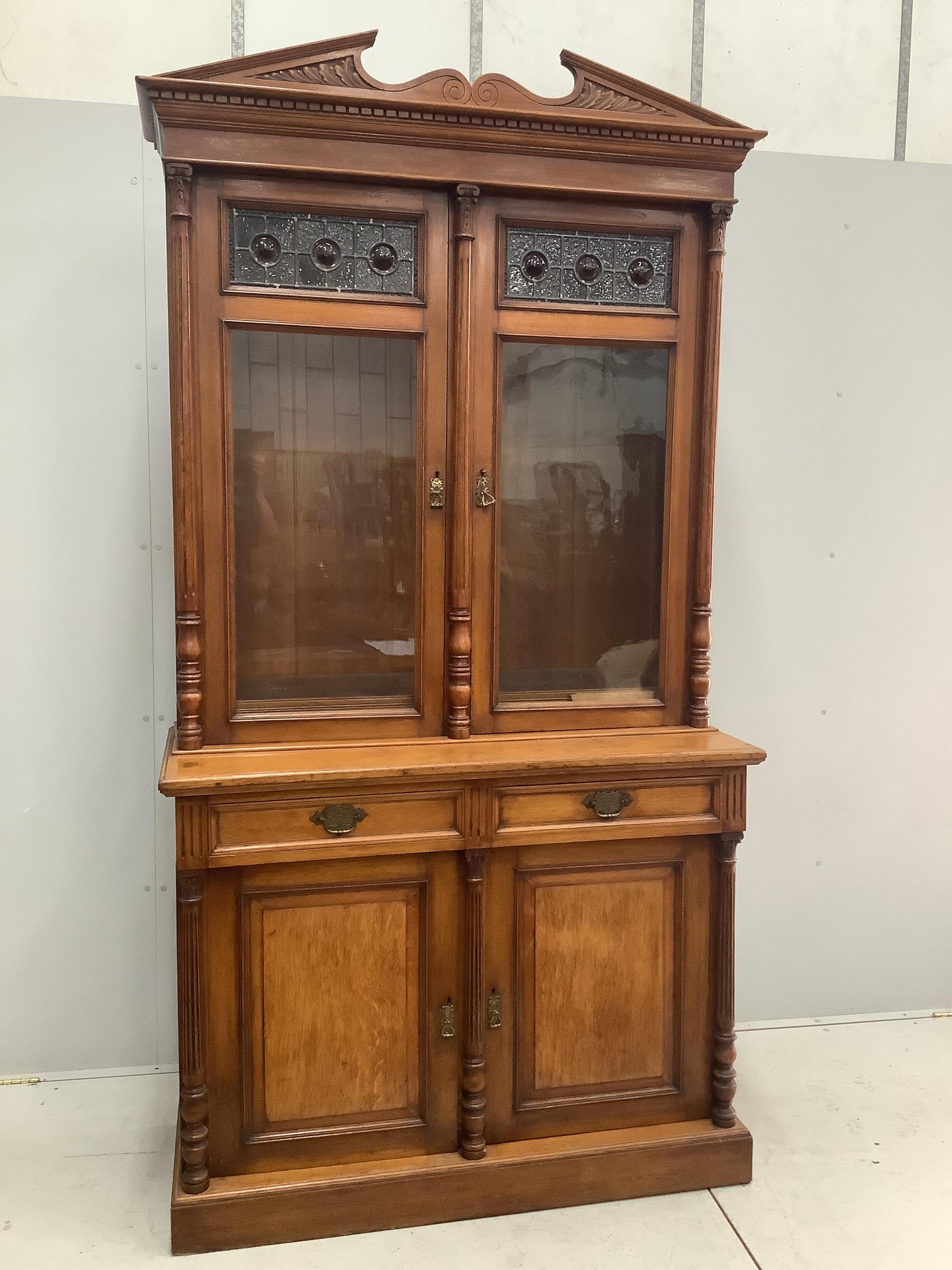 A late Victorian golden oak bookcase, width 123cm, height 238cm. Condition - fair